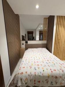 a bedroom with a large bed with a floral bedspread at Residenza Europa in Budrio