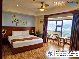 a hotel room with a bed and a table at 456 Hotel in Baguio