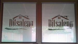 a window with a sign for a house at Ditsaleng Bed and Breakfast in Vanderbijlpark