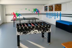 a room with a bench and a table and paintings on the wall at Stunning Beachfront 2BR Condo in Juan Dolio in Juan Dolio