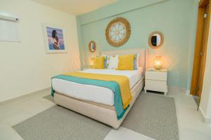 a bedroom with a large bed with yellow pillows at Stunning Beachfront 2BR Condo in Juan Dolio in Juan Dolio +45 photos