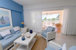 a living room with a couch and a table at Stunning Beachfront 2BR Condo in Juan Dolio in Juan Dolio