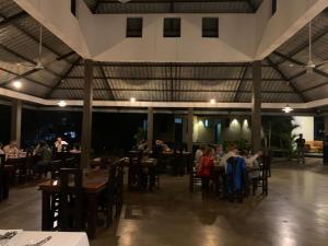 a restaurant with tables and people sitting at tables at Nature Luxe Sigiriya in Sigiriya