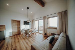 a living room with a couch and a table at Kleinberg Chalet in Filzmoos