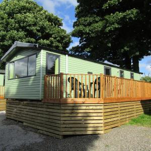 a tiny house with a deck on top at Barnkirk Holidays in Newton Stewart