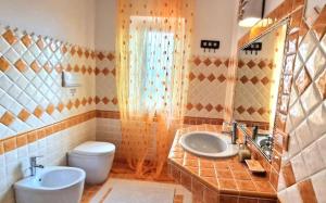 a bathroom with a toilet and a sink at Villa Bellavista Palau in Barrabisa +32 photos