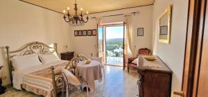 a bedroom with a bed and a table and a window at Villa Bellavista Palau in Barrabisa