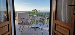 a table and chairs on a balcony with a view at Villa Bellavista Palau in Barrabisa