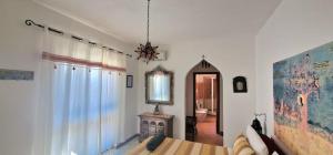 a bedroom with a bed and a mirror on the wall at Villa Bellavista Palau in Barrabisa