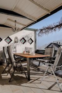 a wooden table and chairs on a patio at Landhaus Danita in Bodensdorf