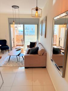 a living room with a couch and a mirror at ERA home boutique in Eilat