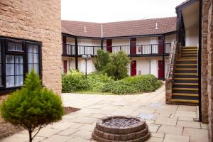 a building with a staircase and a courtyard at The Bowman by Greene King Inns in Nottingham