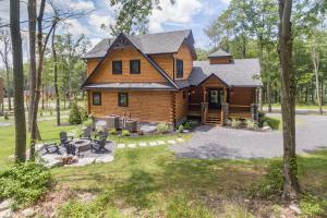 a log cabin in the woods with a yard at Cabin Collina by Railey Vacations in McHenry