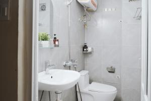 a white bathroom with a sink and a toilet at Toda House - 4Bedroom near Hoan Kiem Lake in Hanoi +29 photos