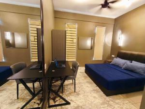 a bedroom with a bed and a desk and a mirror at Homestay Naufal Bandar Sri Sendayan Ground Floor in Seremban +29 photos