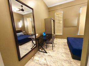 a room with a mirror and a desk and a bed at Homestay Naufal Bandar Sri Sendayan Ground Floor in Seremban