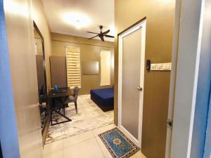a hallway to a room with a bedroom and a desk at Homestay Naufal Bandar Sri Sendayan Ground Floor in Seremban