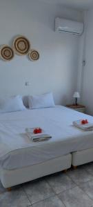 a white bed with towels and red roses on it at APARTMENT Sonia in Análipsis