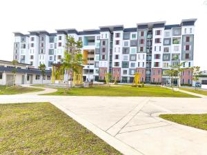 a large apartment building with a playground in front of it at Homestay Naufal Bandar Sri Sendayan Ground Floor in Seremban