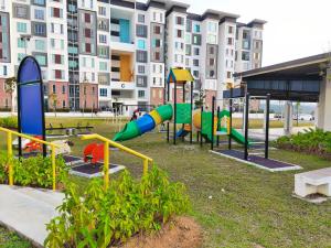a playground in a park in front of a building at Homestay Naufal Bandar Sri Sendayan Ground Floor in Seremban
