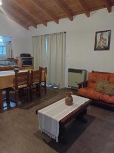 a living room with a couch and a table at Cabañas Rincon Verde in Merlo