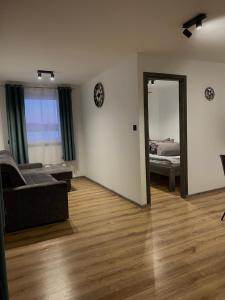 a living room with a couch and a mirror at Zacisze nad wodą in Strzegocice