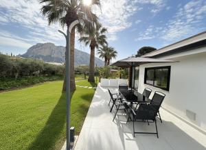 a patio with chairs and a table with a view at Casa Manzella Apartments in Cinisi
