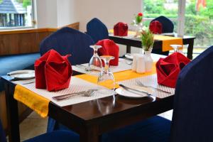 a table with red napkins on top of it at Unique Cottages in Nuwara Eliya