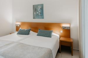 a bedroom with a white bed and a wooden headboard at Hotel Sao Sebastiao de Boliqueime in Boliqueime +57 photos