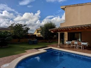 a swimming pool in a yard with a table and chairs at EVH105 - Casa con piscina privada in Tossa de Mar
