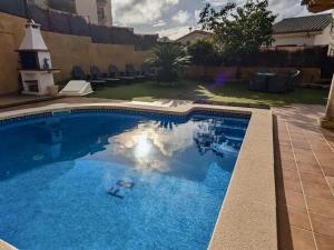 a swimming pool with blue water in a yard at EVH105 - Casa con piscina privada in Tossa de Mar