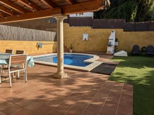 a patio with a pool and a table and a umbrella at EVH105 - Casa con piscina privada in Tossa de Mar +33 photos