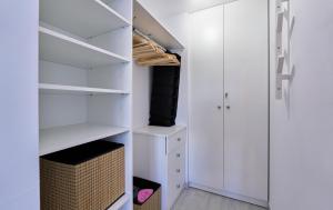 a white walk in closet with white shelves at Sea Casa Rosa in Mijas Costa
