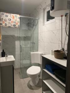 a bathroom with a shower and a toilet and a sink at Zacisze nad wodą in Strzegocice +27 photos