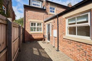 a brick building with a door and a window at Host & Stay - The Station Cottage in Stanley