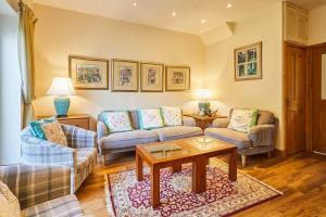 a living room with two couches and a coffee table at Host & Stay - The Station Cottage in Stanley