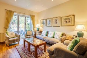 a living room with two couches and a coffee table at Host & Stay - The Station Cottage in Stanley