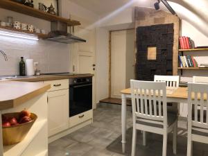 a kitchen with a table and chairs and a stove at TrailHouse in Liptovský Mikuláš +3 photos