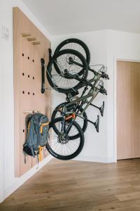 a bike hanging on a wall in a room at Gravity Haus Moab in Moab