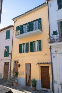 a building with green shuttered windows and balconies at Acqua Dolce in Capodimonte