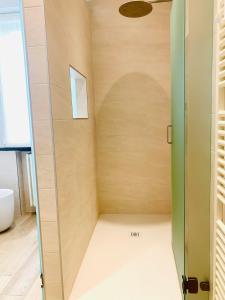 a walk in shower with a glass door at Modern 90sqm Apt - Ideal Base for Parma & Modena in Cavriago +38 photos