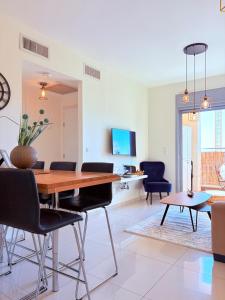 a dining room with a wooden table and chairs at ERA home boutique in Eilat