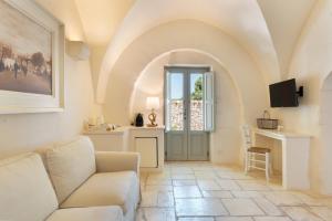 a living room with a couch and a table at Masseria Le Carrube in Ostuni