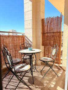a table and two chairs on a balcony at ERA home boutique in Eilat