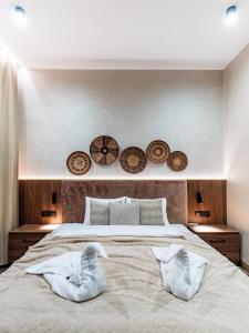 a bedroom with a large bed with two pillows on it at LookTatry Tatra Stone House z Jacuzzi in Kościelisko