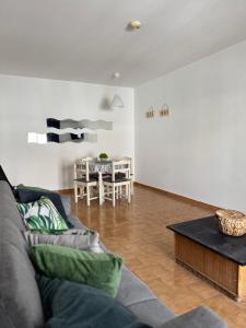 a living room with a couch and a table at Mira T1 Apartment in Carvoeiro