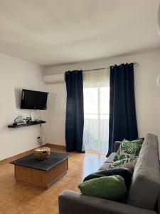 a living room with a couch and a coffee table at Mira T1 Apartment in Carvoeiro