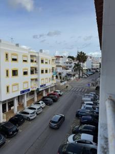 a row of cars parked in a parking lot at Mira T1 Apartment in Carvoeiro