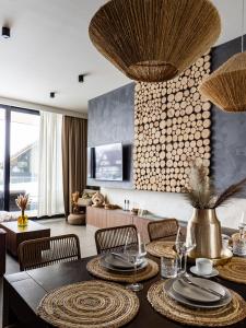a living room with a dining room table and chairs at LookTatry Tatra Stone House z Jacuzzi in Kościelisko