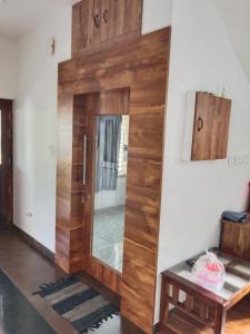 a wooden door in a room with a table at GG Residency INN in Palakkad